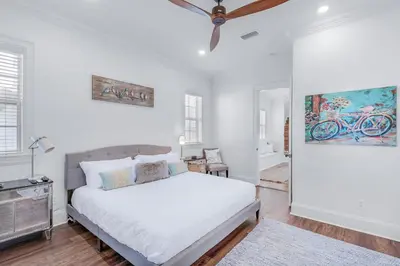 a bedroom with a bed and a painting on the wall at Seas the Day on 30A in Santa Rosa Beach