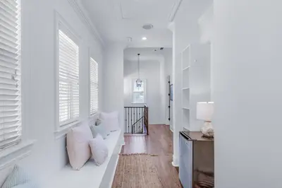 a white living room with white walls and windows at Seas the Day on 30A in Santa Rosa Beach