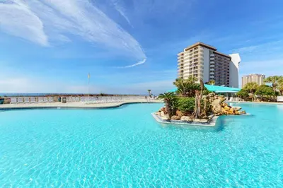 a resort with blue water and a tall building at Edgewater Tower 3-1012 in Panama City Beach