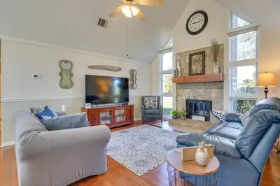 a living room with two couches and a fireplace at Southport Getaway with Private Pool about 15 Mi to PCB! in Southport