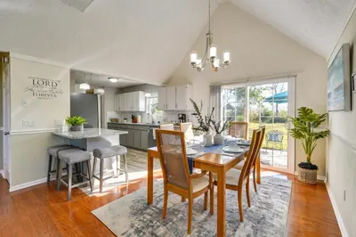 a kitchen and dining room with a table and chairs at Southport Getaway with Private Pool about 15 Mi to PCB! in Southport