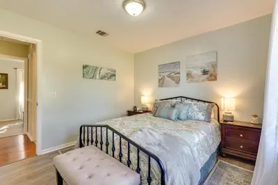 a bedroom with a bed and a bench in it at Southport Getaway with Private Pool about 15 Mi to PCB! in Southport