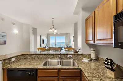 a kitchen with a sink and a counter top at Sunrise Beach #903 in Panama City Beach