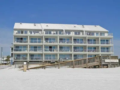 a large building on the beach next to the sand at Commodores Retreat #205 in Santa Rosa Beach