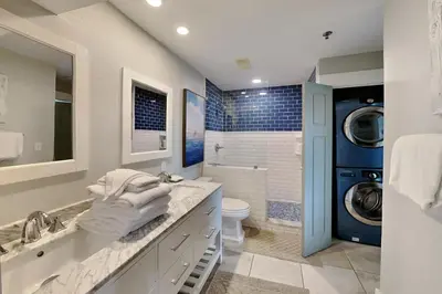 a bathroom with a sink and a washing machine at Commodores Retreat #205 in Santa Rosa Beach