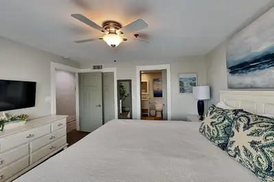 a bedroom with a bed and a ceiling fan at Commodores Retreat #205 in Santa Rosa Beach