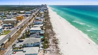 an aerial view of a beach with houses and the ocean at Beach House - Family Tides by Panhandle Getaways in Panama City Beach