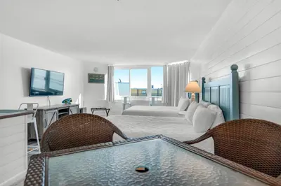 a bedroom with a bed and a tub in a room at Top of the Gulf 807 in Panama City Beach