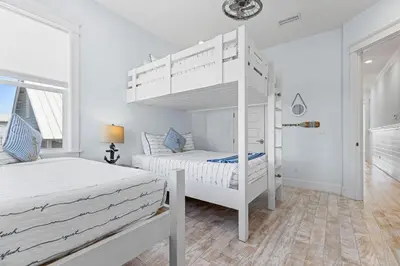 a bedroom with two beds and a bunk bed at Flor Da Li by the Sea in Inlet Beach