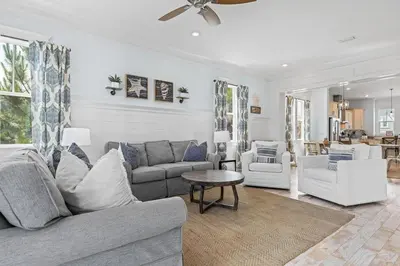 a living room with a couch and a table and chairs at Flor Da Li by the Sea in Inlet Beach