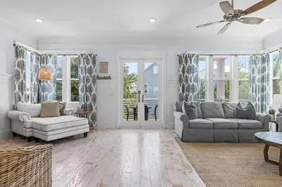 a living room with two couches and a ceiling fan at Flor Da Li by the Sea in Inlet Beach