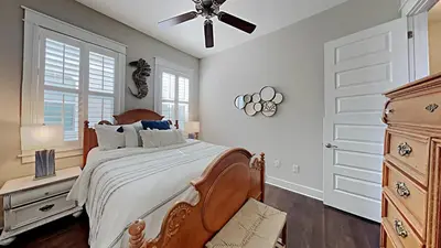 a bedroom with a bed and a ceiling fan at Prominece 30A - Beach Retreat in Santa Rosa Beach