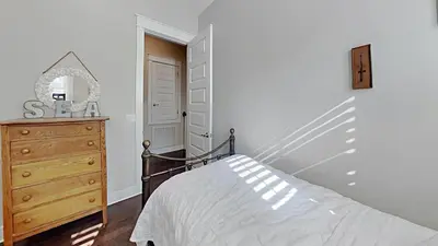 a bedroom with a bed and a dresser and a mirror at Prominece 30A - Beach Retreat in Santa Rosa Beach