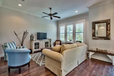 a living room with a couch and a tv at Prominece 30A - Coasting Inn in Watersound Beach