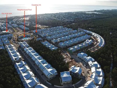 an overhead view of a building complex with blue and white roofs at Prominece 30A - Coasting Inn in Watersound Beach