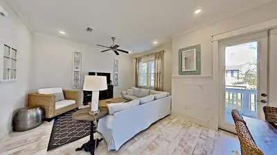 a living room with a couch and a table at Prominence 30A - Holiday House in Watersound Beach