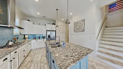 a kitchen with a sink and a counter top at Prominence 30A - Holiday House in Watersound Beach