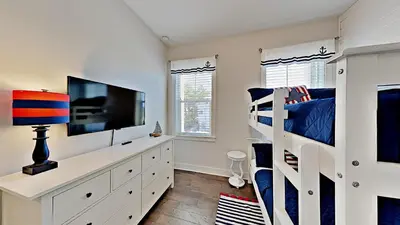 a bedroom with a bunk bed and a television at Prominence 30A - Holiday House in Watersound Beach