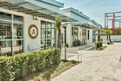 a building with a clock on the side of it at Prominence 30A - Holiday House in Watersound Beach