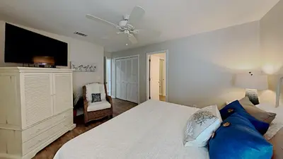 a bedroom with a white bed and a ceiling fan at Beach Happy - Gulf Front in Santa Rosa Beach