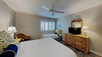a bedroom with a bed and a flat screen tv at Beach Happy - Gulf Front in Santa Rosa Beach