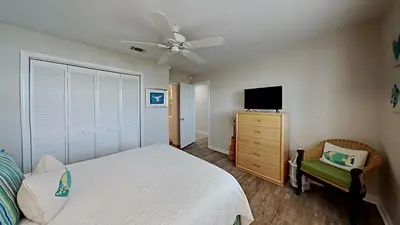 a bedroom with a bed and a flat screen tv at Beach Happy - Gulf Front in Santa Rosa Beach