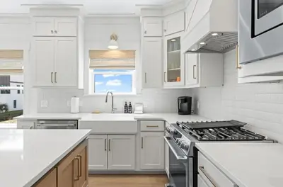 a white kitchen with a sink and a stove at 26 Blue Coast Ct in Inlet Beach