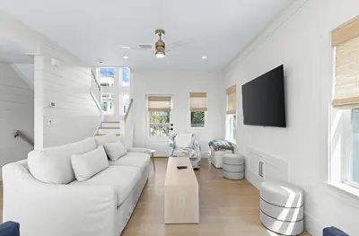 a living room with a white couch and a tv at 26 Blue Coast Ct in Inlet Beach