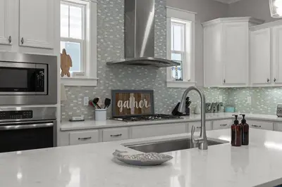 a kitchen with a sink and a stove top oven at Sea Haven At Prominence in Watersound Beach