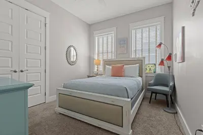 a bedroom with a bed and a desk and a chair at Sea Haven At Prominence in Watersound Beach