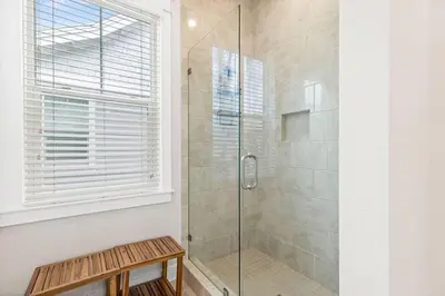 a bathroom with a shower with a glass door at Prominence 30A - TipSea Kitty in Santa Rosa Beach