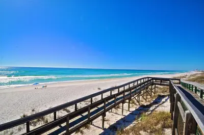 a boardwalk leading to a beach with the ocean at Prominence 30A - TipSea Kitty in Santa Rosa Beach