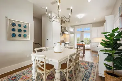 a dining room with a white table and chairs at Paradise Found on 30A in Santa Rosa Beach