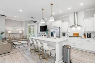a kitchen and living room with a large white island at Seas The Day 30A in Santa Rosa Beach