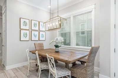 a dining room with a wooden table and chairs at Seas The Day 30A in Santa Rosa Beach