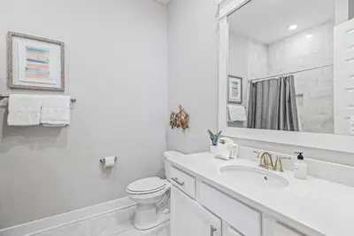 a white bathroom with a sink and a toilet at Seas The Day 30A in Santa Rosa Beach