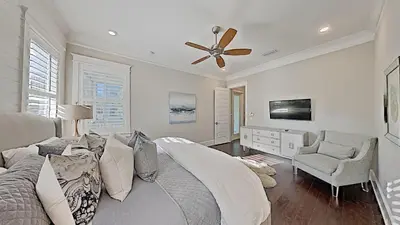 a bedroom with a bed and a ceiling fan at Prominence Southside - Blue Skies in Watersound Beach