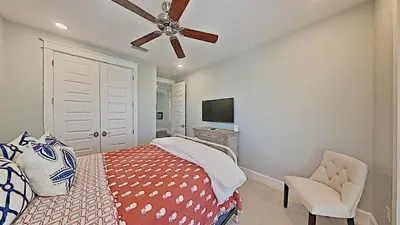 a bedroom with a bed and a ceiling fan at Prominence Southside - Blue Skies in Watersound Beach