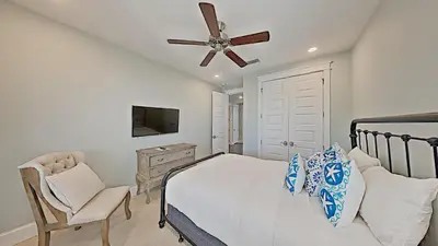 a bedroom with a bed and a ceiling fan at Prominence Southside - Blue Skies in Watersound Beach