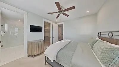 a bedroom with a bed and a ceiling fan at Prominence Southside - Blue Skies in Watersound Beach