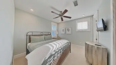 a bedroom with a bed and a ceiling fan at Prominence Southside - Blue Skies in Watersound Beach