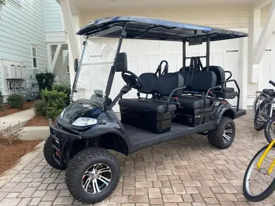 a golf cart parked in front of a house at Prominence 30A - Hey Hey 30A in Inlet Beach