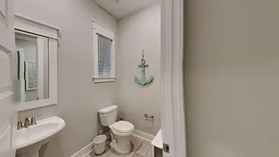 a bathroom with a white toilet and a sink at Prominence 30A - Hey Hey 30A in Inlet Beach