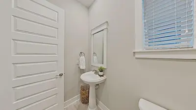 a white bathroom with a sink and a mirror at Prominence 30A - Hey Hey 30A in Inlet Beach