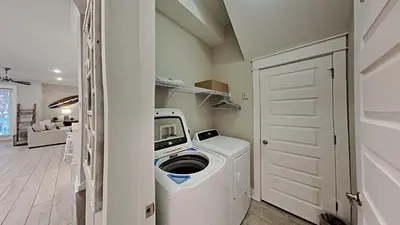 a washer and dryer in a room with a door at Prominence 30A - Hey Hey 30A in Inlet Beach