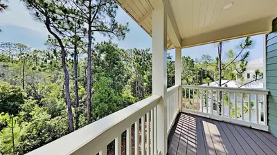 a balcony with a view of the woods at Pines and Palmettos in Santa Rosa Beach