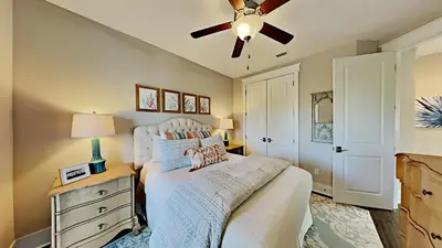 a bedroom with a bed and a ceiling fan at Pines and Palmettos in Santa Rosa Beach