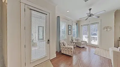 a living room with a ceiling fan and windows at Prominence 30A - Mint Julep in Inlet Beach
