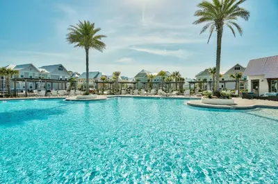 a swimming pool at a resort with palm trees at Prominence 30A - Mint Julep in Inlet Beach