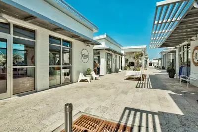 a walkway in front of a building with windows at Prominence 30A - Mint Julep in Inlet Beach